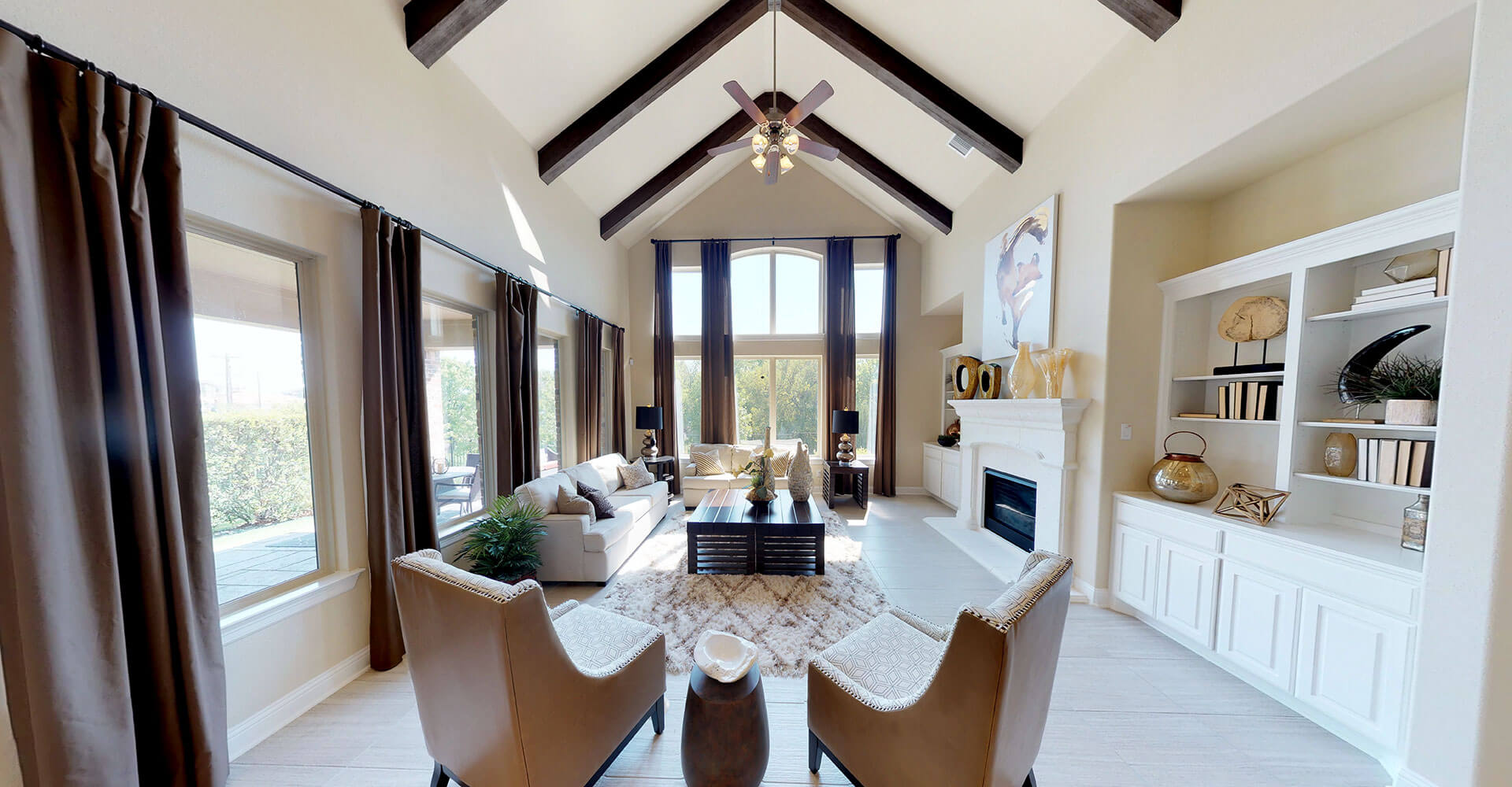 Interior of a great room with vaulted ceilings and tall wondows