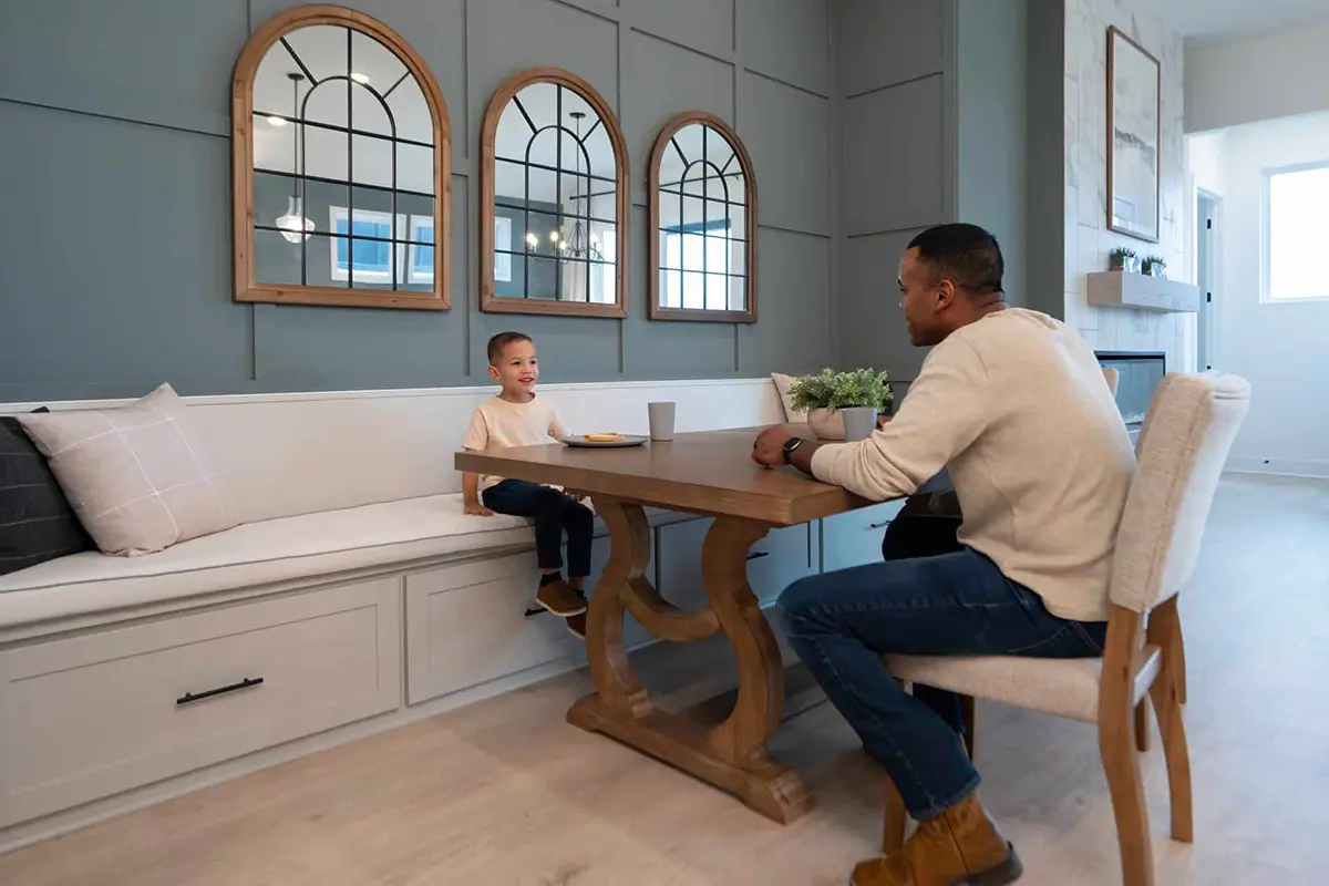 Man and son sitting at kitchen table