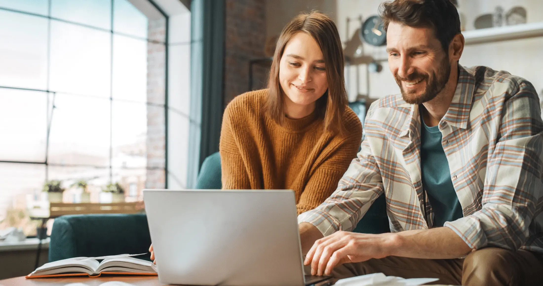 Man and woman at computer looking at mortgage rates