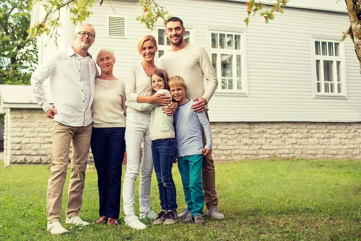 Happy family in front of home